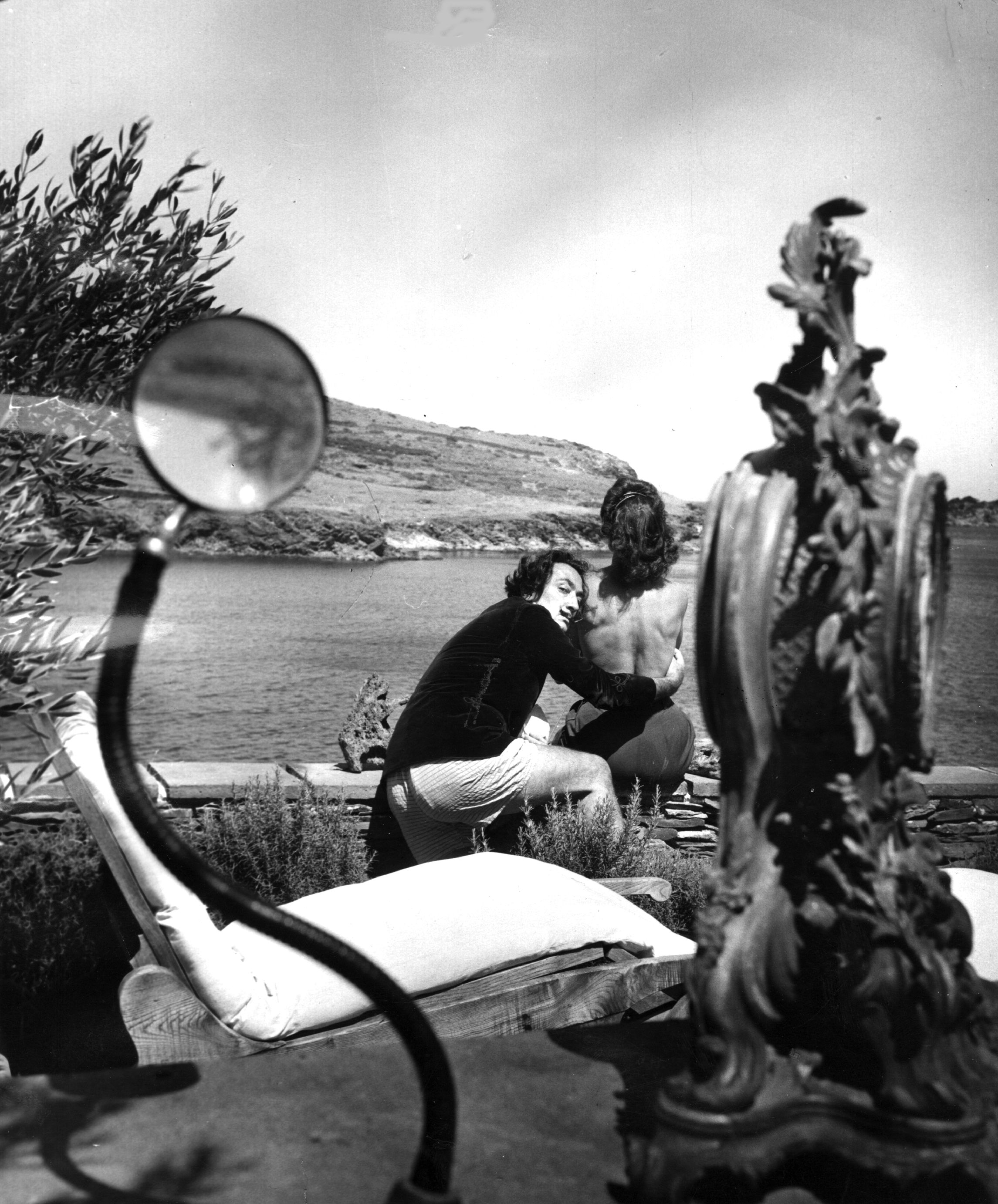 Spanish surrealist artist Salvador Dali (1904 - 1989) with his wife Gala (1894 - 1982) at the garden of his home in Cadaques on the Spanish Costa Brava